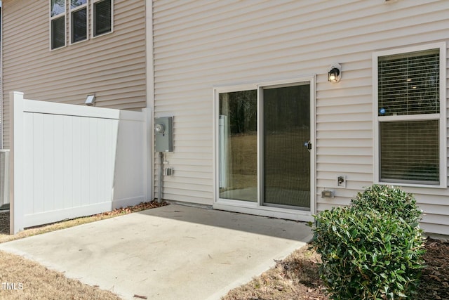 property entrance featuring a patio area and fence