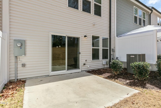 rear view of property featuring a patio area and central air condition unit