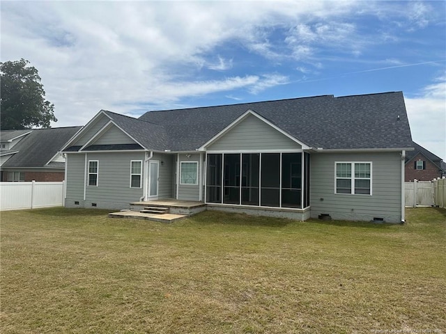 back of property featuring a sunroom, crawl space, fence, and a lawn