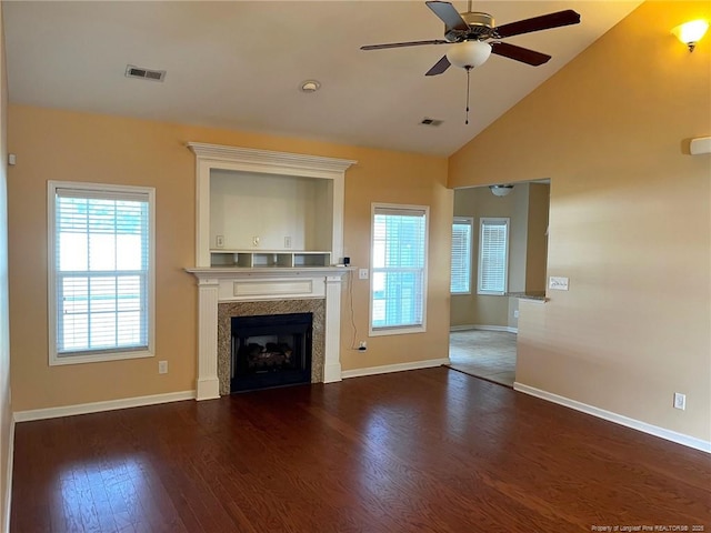 unfurnished living room featuring vaulted ceiling, visible vents, a fireplace, and wood finished floors