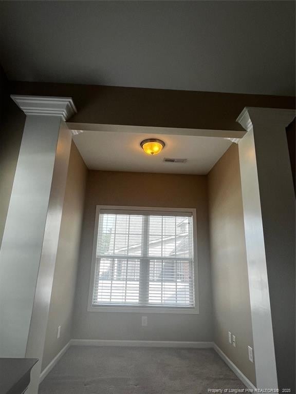 interior space featuring carpet floors, baseboards, and visible vents