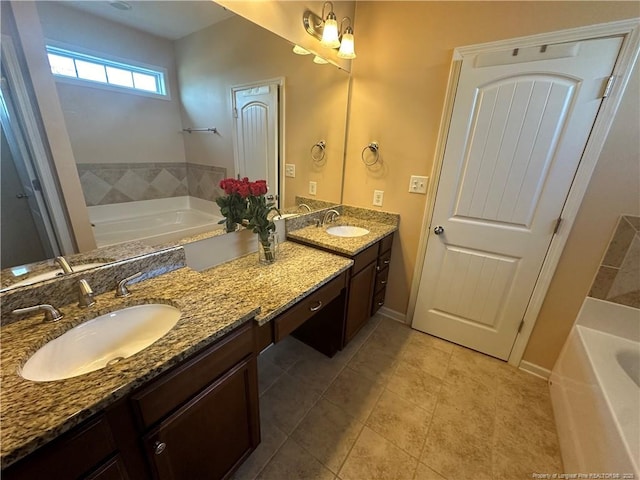 bathroom featuring a garden tub, double vanity, a sink, and tile patterned floors