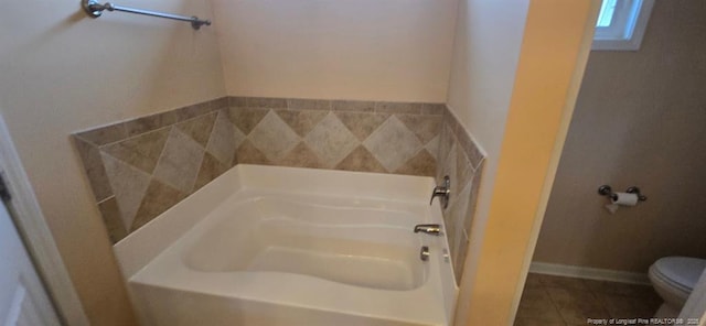 full bathroom featuring a tub, tile patterned flooring, and toilet