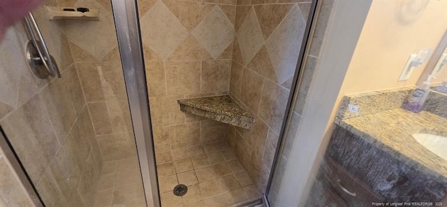 bathroom with a shower stall and vanity