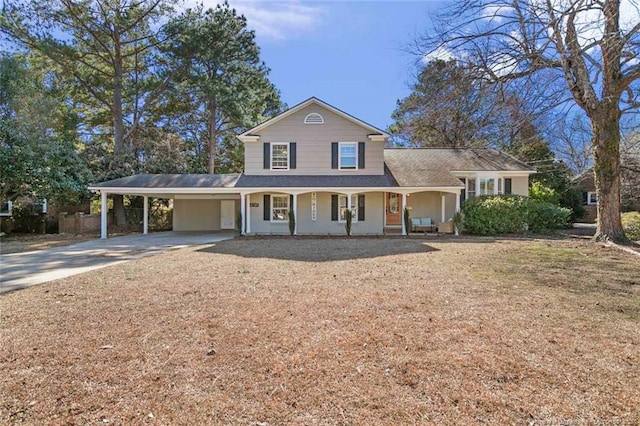 view of front of house featuring driveway, covered porch, and a carport