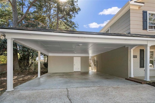 view of parking / parking lot featuring an attached carport and driveway