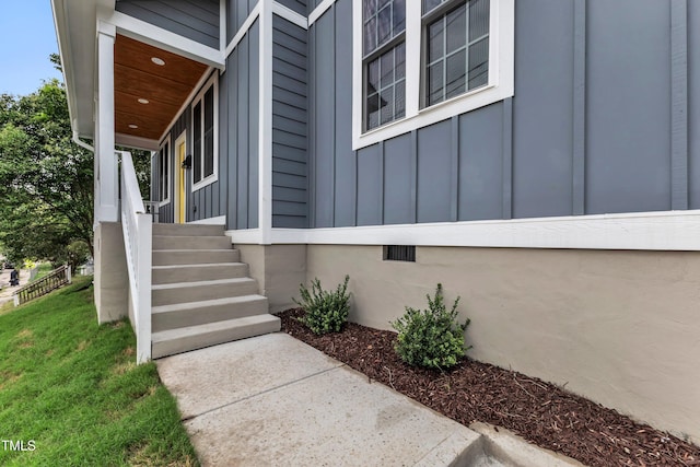 entrance to property with crawl space, a porch, and board and batten siding