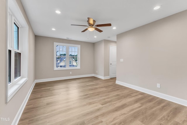 spare room featuring light wood-type flooring, ceiling fan, baseboards, and recessed lighting