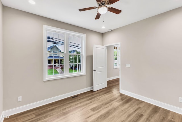 spare room featuring recessed lighting, visible vents, ceiling fan, wood finished floors, and baseboards