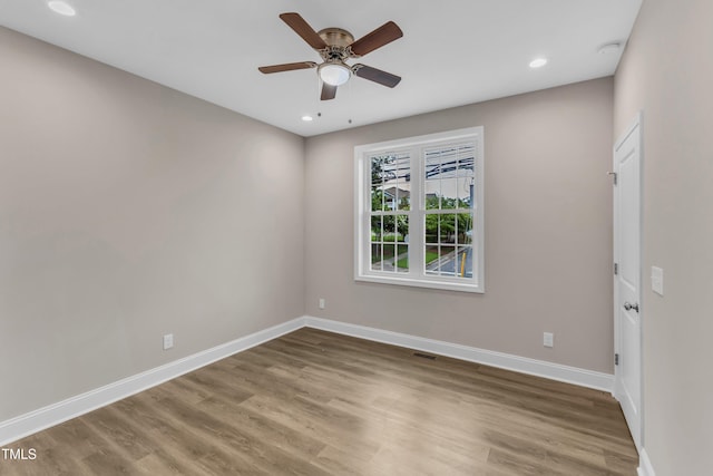 empty room featuring visible vents, baseboards, ceiling fan, and wood finished floors