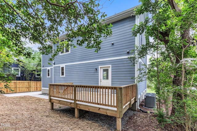 back of property featuring central air condition unit, fence, and a wooden deck