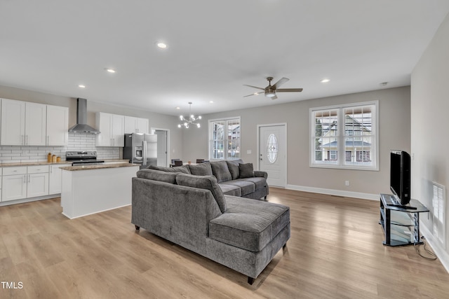 living area featuring light wood finished floors, plenty of natural light, and recessed lighting