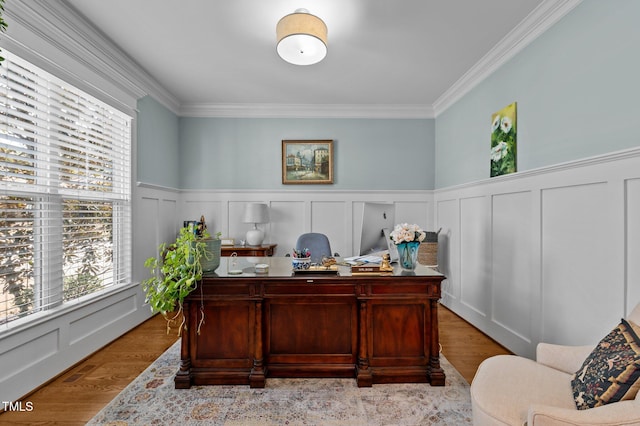 office area with a wealth of natural light, crown molding, and a decorative wall