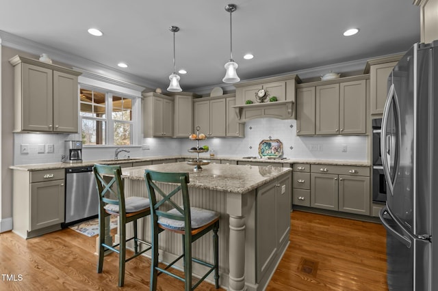 kitchen featuring a kitchen island, gray cabinets, appliances with stainless steel finishes, and ornamental molding