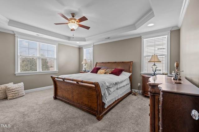 bedroom featuring light carpet, baseboards, and a tray ceiling