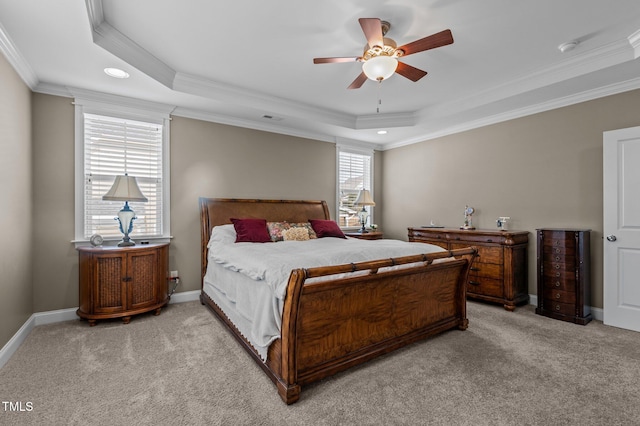 bedroom with light carpet, a raised ceiling, baseboards, and ornamental molding