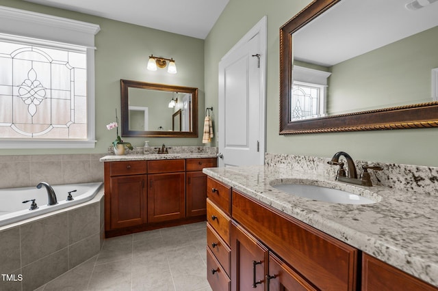 bathroom with a bath, tile patterned flooring, two vanities, and a sink