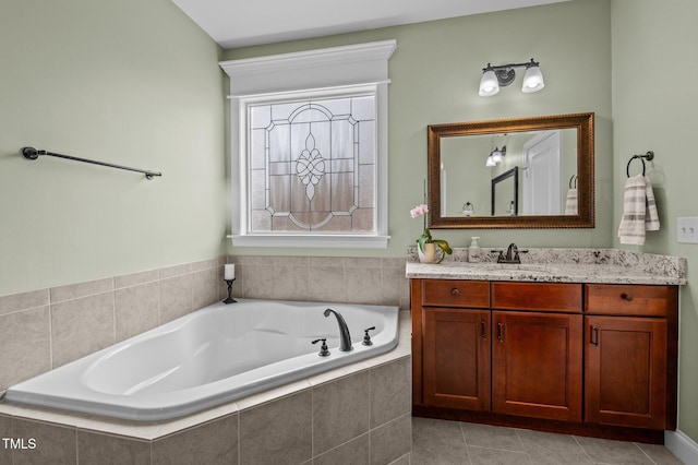 bathroom with vanity, tile patterned floors, and a bath