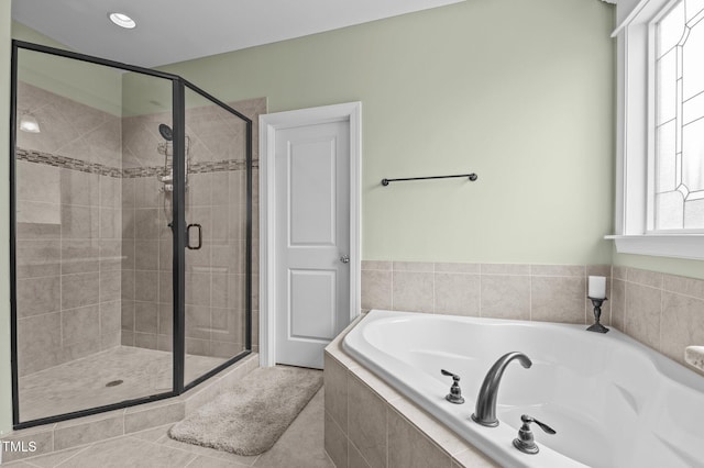 full bathroom featuring a stall shower, tile patterned flooring, and a bath