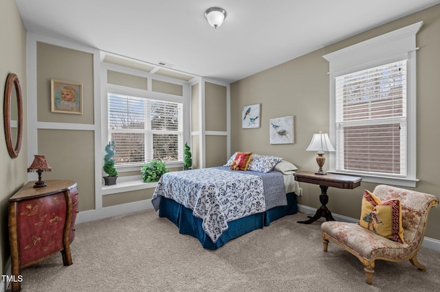 bedroom featuring visible vents, baseboards, and carpet