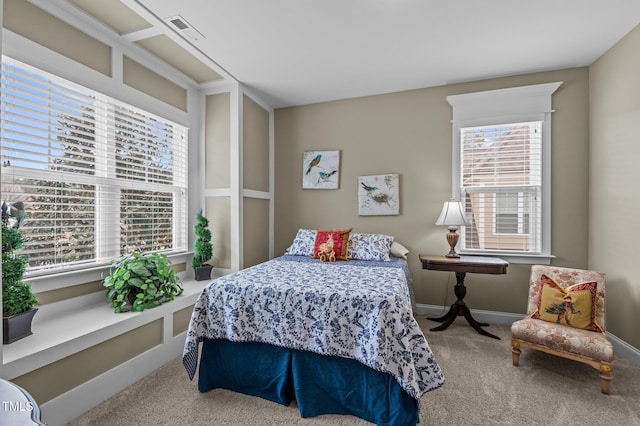 bedroom with baseboards, multiple windows, carpet, and visible vents