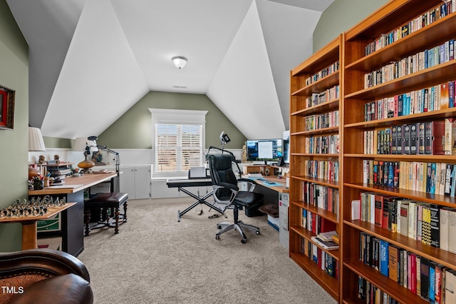 carpeted office space featuring lofted ceiling