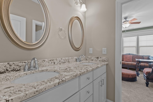 bathroom with a sink, a ceiling fan, and double vanity