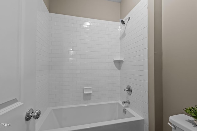 bathroom featuring shower / bathing tub combination and toilet