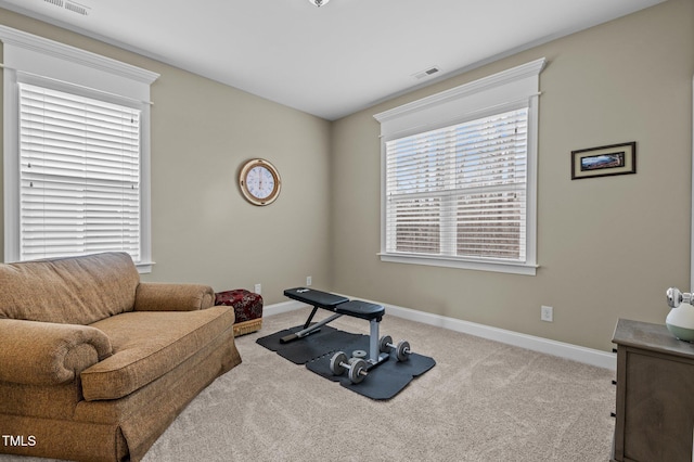 workout area with visible vents, baseboards, and carpet floors