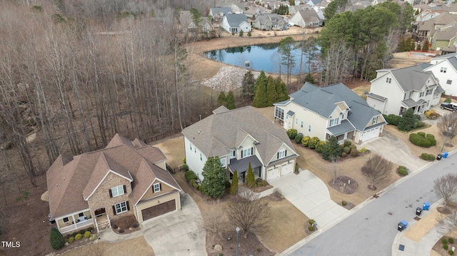 drone / aerial view with a residential view and a water view