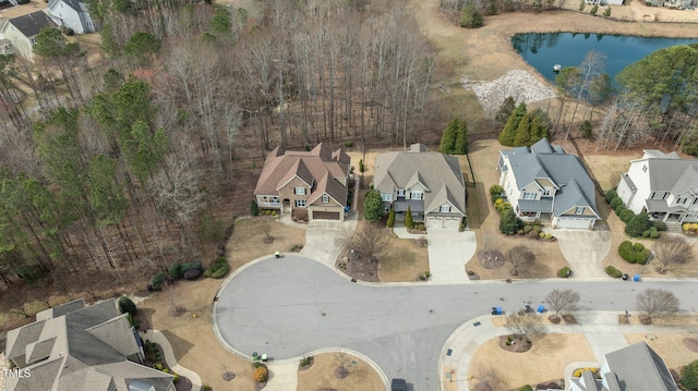 drone / aerial view featuring a residential view and a water view