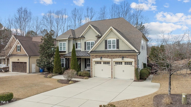 view of front of house featuring stone siding, driveway, and roof with shingles