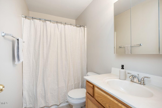 bathroom featuring vanity, curtained shower, and toilet