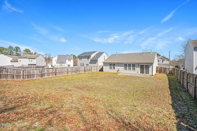 view of yard with a fenced backyard and a residential view