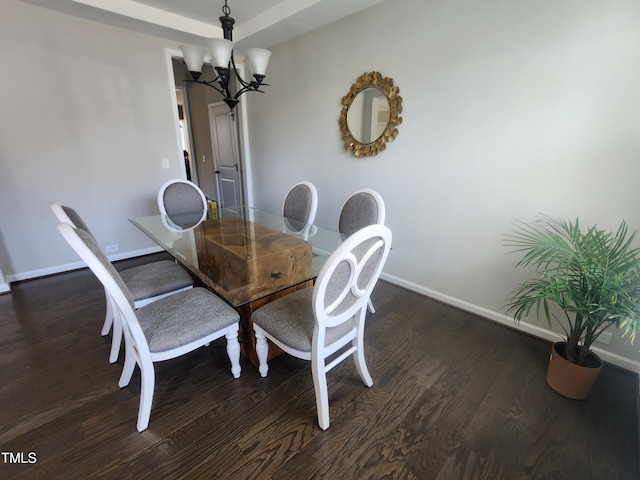 dining space with baseboards, an inviting chandelier, and dark wood-style flooring