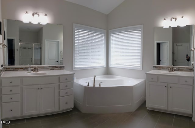 bathroom with a sink, backsplash, a stall shower, and vaulted ceiling