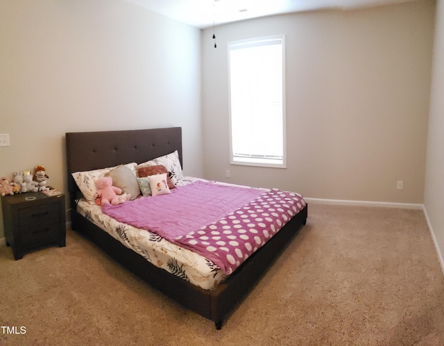 bedroom with baseboards and carpet