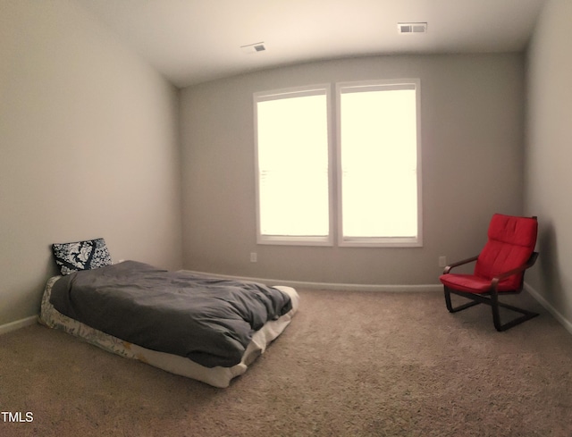 bedroom with lofted ceiling, carpet flooring, baseboards, and visible vents