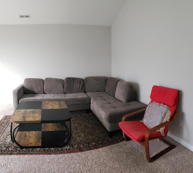 living area featuring visible vents, baseboards, and carpet