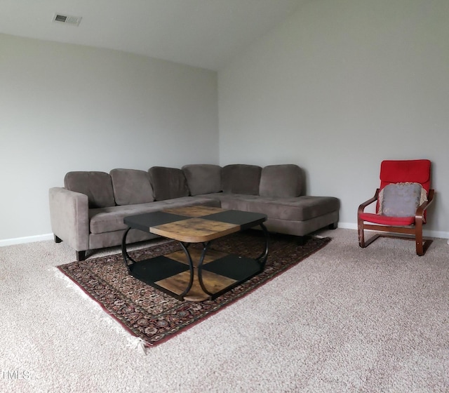 carpeted living room featuring visible vents and baseboards