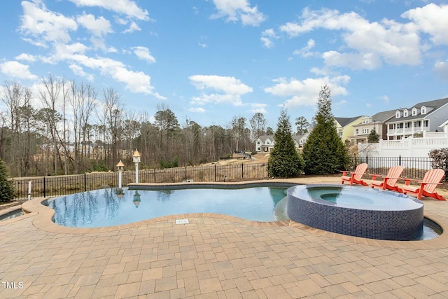 view of swimming pool with a patio, a fenced backyard, and a pool with connected hot tub