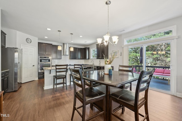 dining space featuring recessed lighting, a chandelier, and dark wood-style floors