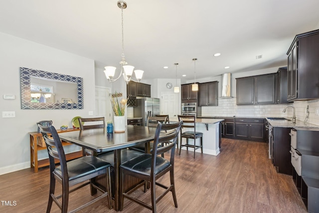 dining area featuring recessed lighting, dark wood-style floors, baseboards, and a chandelier