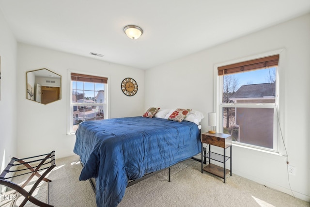 bedroom with visible vents and carpet floors