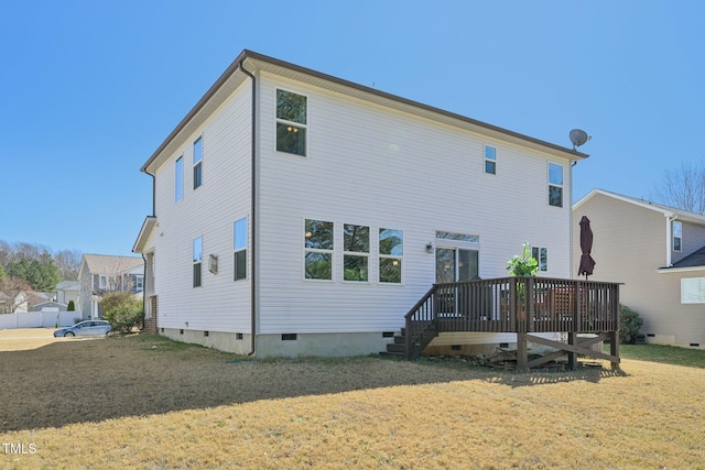 back of property with crawl space, a yard, and a wooden deck