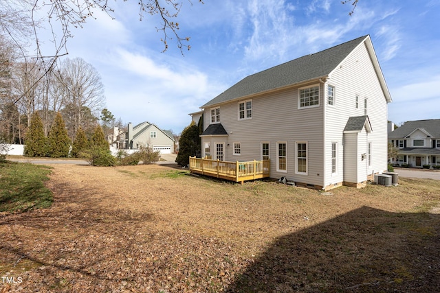 rear view of property featuring a deck, crawl space, and central air condition unit