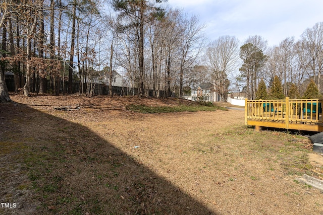 view of yard featuring fence and a deck