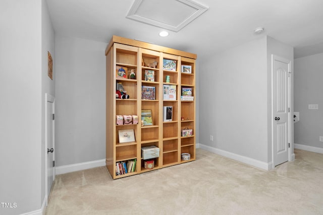 interior space featuring attic access, baseboards, and carpet flooring