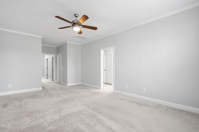 empty room featuring light carpet, ceiling fan, baseboards, and crown molding