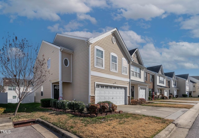 view of front of home featuring a garage, a residential view, and driveway